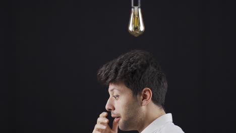 Young-Man-With-An-Idea.-A-light-bulb-is-burning-above-his-head.